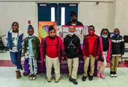 Northeast Delta Human Services Authority’s Louisiana Partnership For Success Manager K’Shana Hall stands with some of the Mind Motivation student essay contest winners.