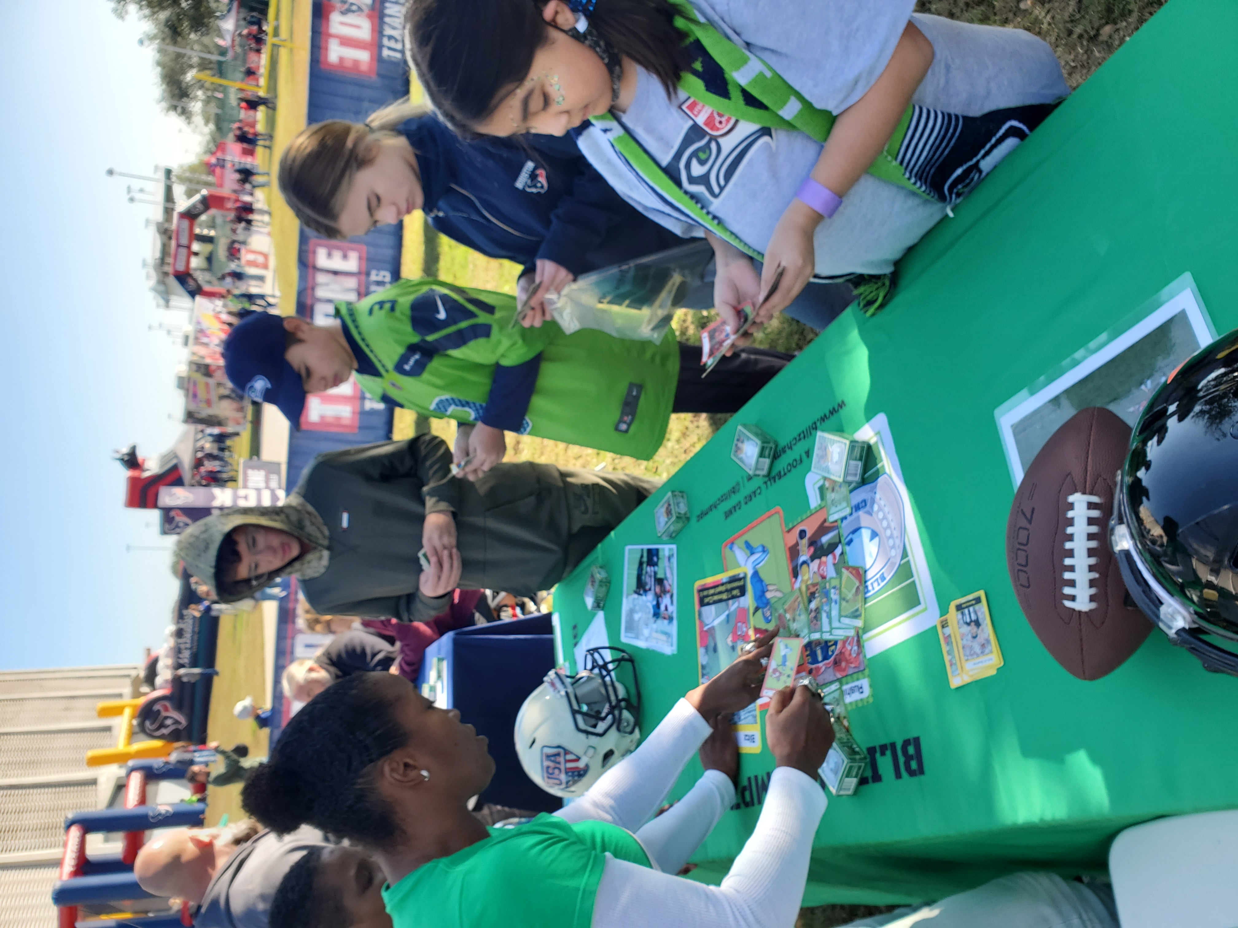 Adrienne Smith demonstrates the excitement of Blitz Champz to youth football fans