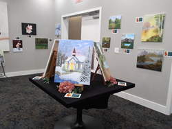 Canvas artwork displayed on table and walls