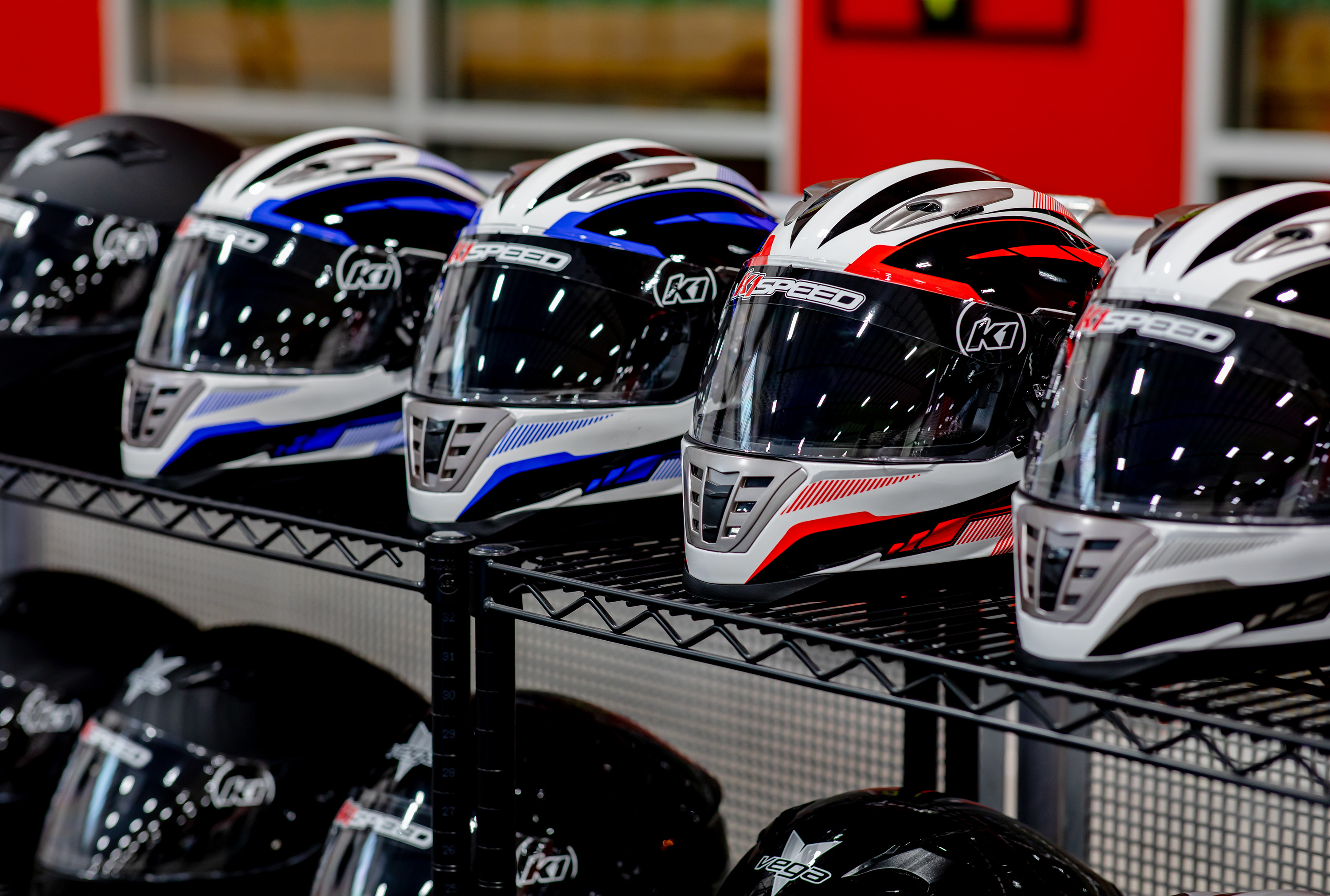 Helmets ready for racers sit neatly in a row at K1 Speed Canton