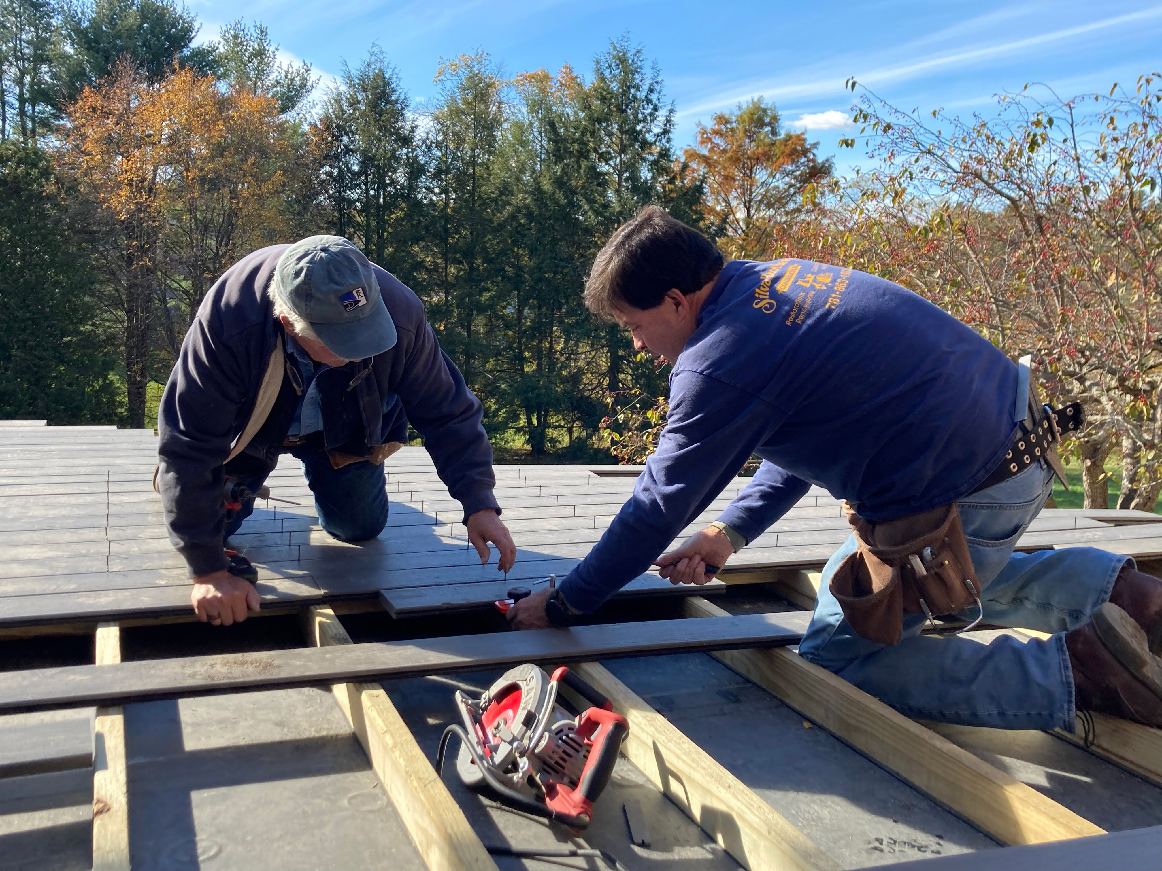 Tom Silva, General Contractor, sets CAMO EDGE clips for fastening as Charlie Silva locks in MoistureShield deck boards with CAMO LEVER.