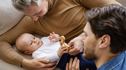 two fathers with their baby