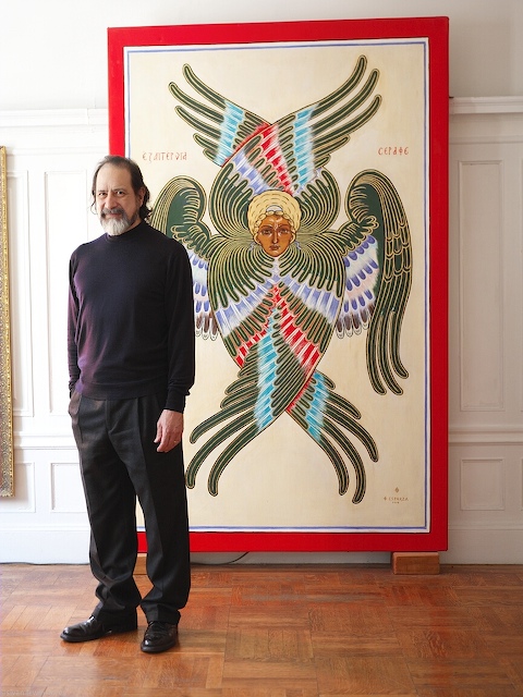 The Artist Guillermo Esparza at his home on the Upper West Side in Manhattan in front of his Green Seraph painting.  Photo by Gil Ortiz.  All Rights Reserved.