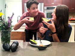 Teens eating avocado