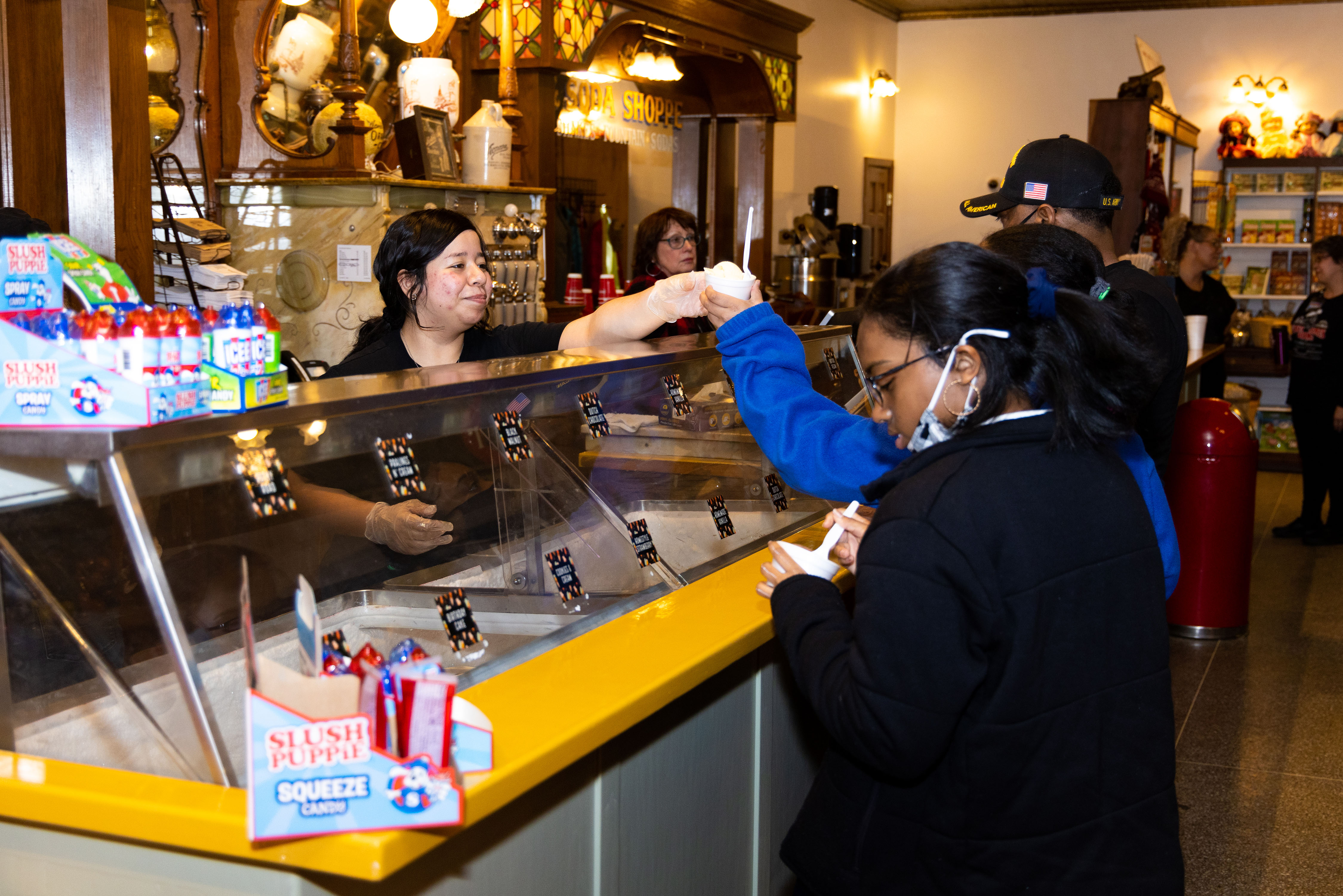 Old Country Store guests enjoy a free scoop of Blue Bell ice cream during the rebranding celebration of Miss Anne's Ice Cream Shoppe  Tuesday, Feb. 15, 2022.