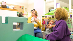 Two female early childhood education students at Los Medanos College holding infants.