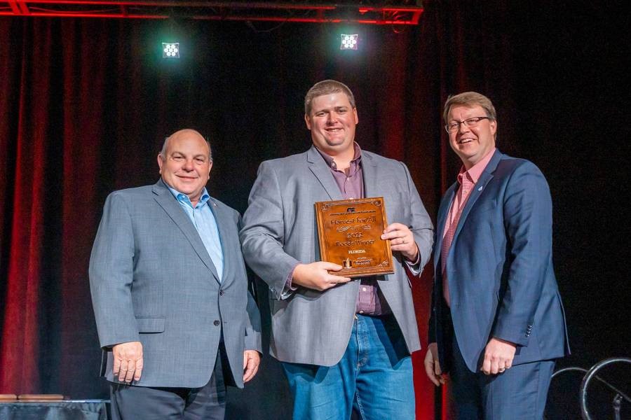 AFBF President Zippy Duvall, left, and Dan Durheim, far right, presented Kevin Lussier, YF&R Class President with the first place award in most food donated for Farm Bureau’s Harvest for All program.