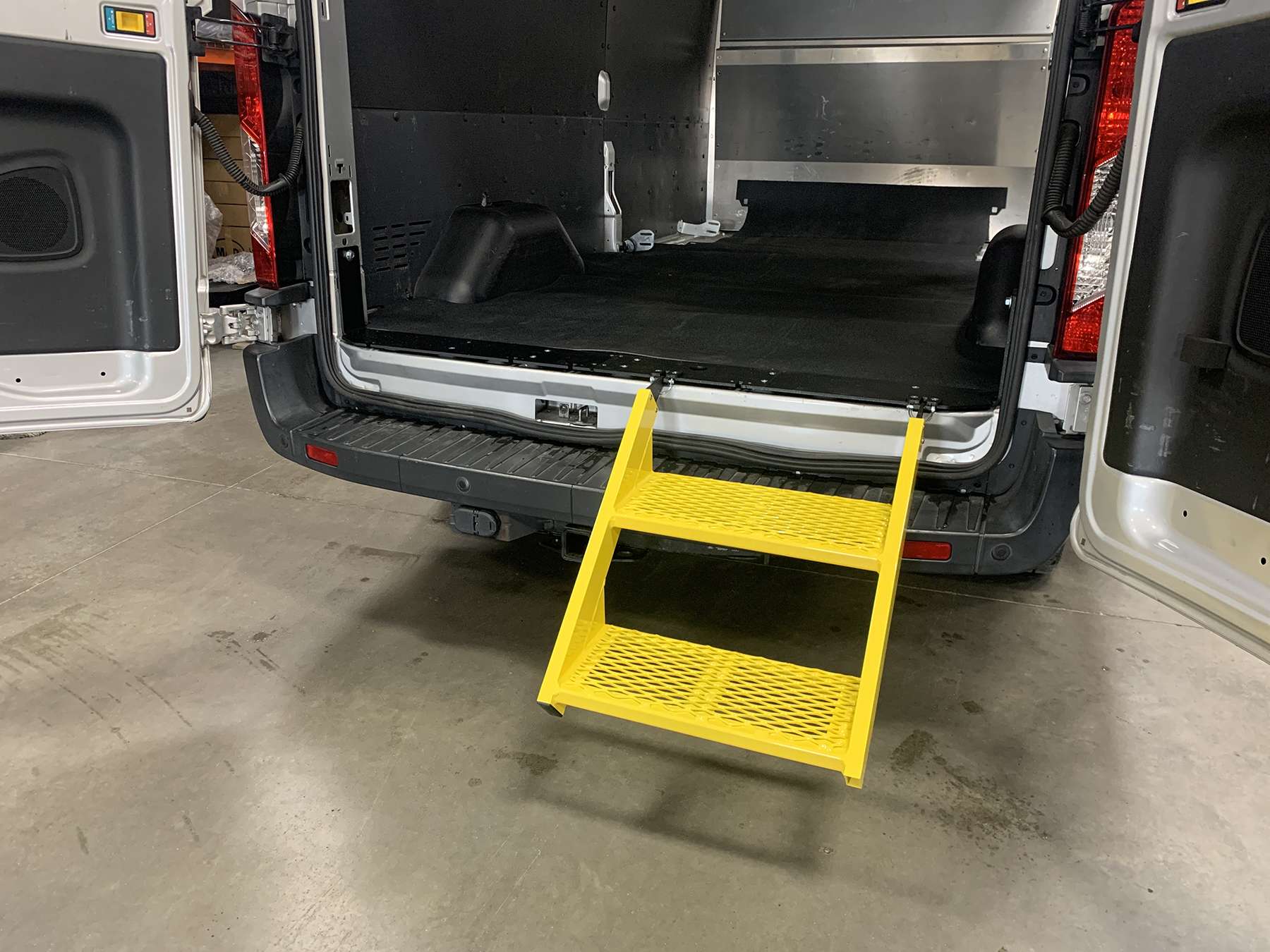 The 22-inch-wide, all-aluminum Van Step folds down to provide effortless three-step entry and egress from the rear of any Ford Transit van.