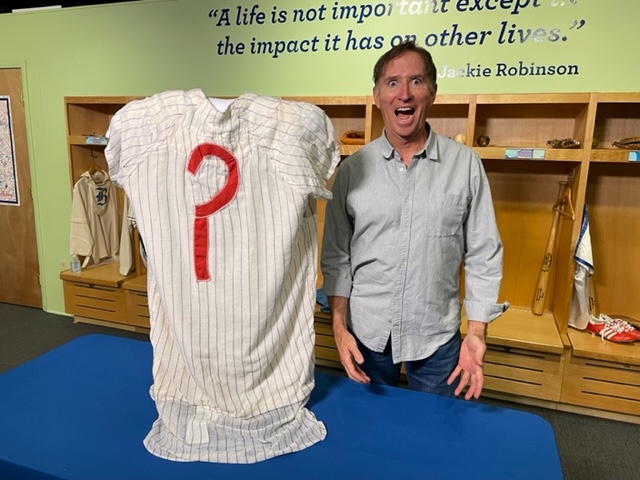 “Max Patkin Documentary” Director, Writer, Producer and Former MiLB Pitcher Greg DeHart with Max’s New York Yankees style pinstripe jersey at the National Baseball Hall of Fame.