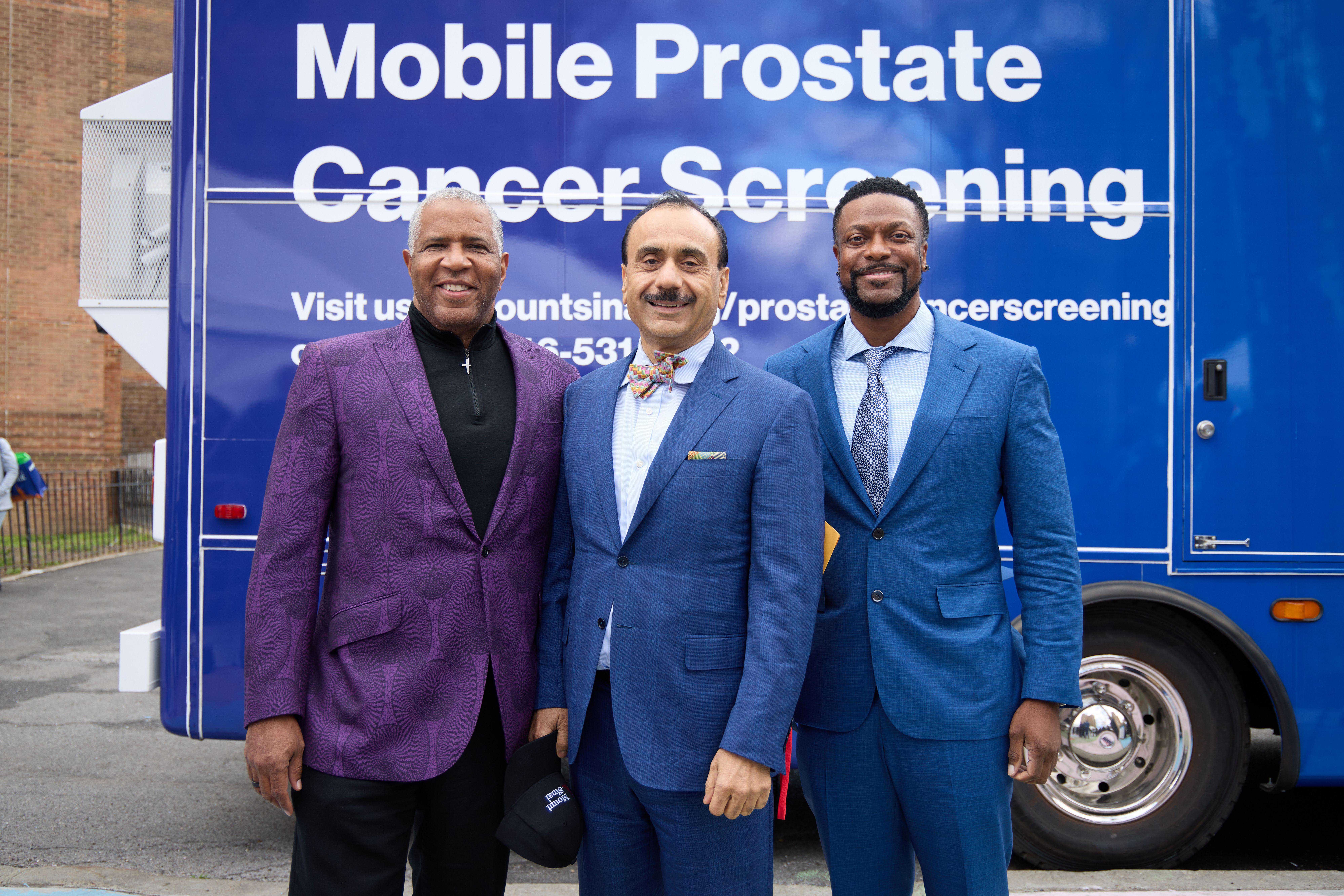 Robert F. Smith, Dr. Ash Tewari and Chris Tucker in front of the mobile prostate cancer screening unit.