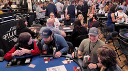 Image of people sitting around a poker table playing Texas Hold'em for a charity event. 