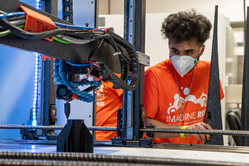 student watching a 3D printer.