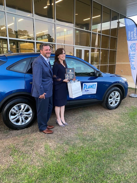 Shawn Burns, GM/OP of Planet Ford in Spring, TX presents new Ford to Spring ISD Teacher of the Year