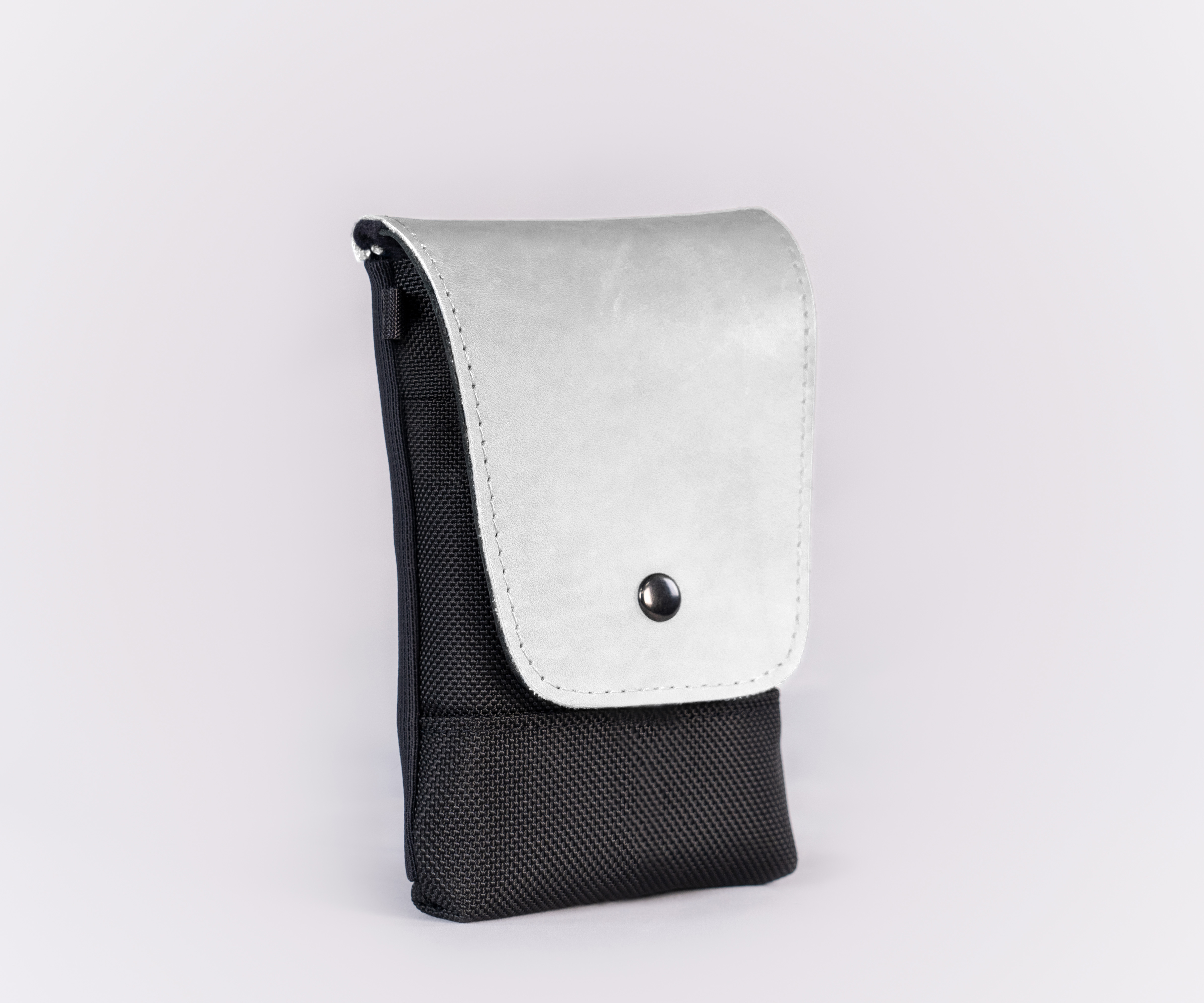 Black ballistic nylon with full-grain white leather flap