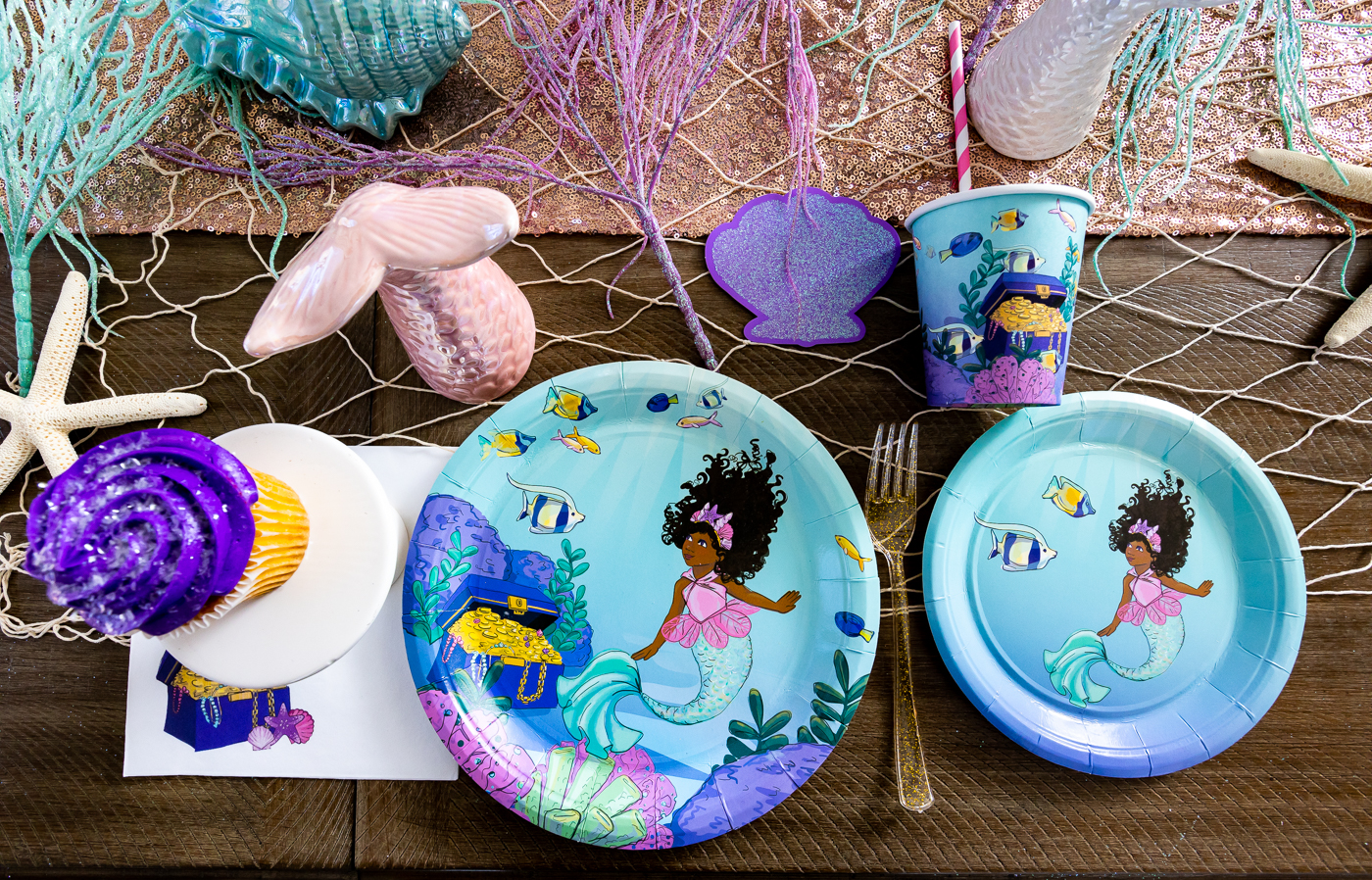 Mermaid party supply collection includes cups, plates and napkins.