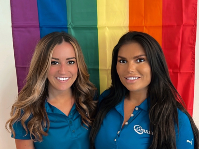 Granite teammates (l to r) Lauren Tuttle and Nicolette Szczepaniak with Pride flag in Granite's Philadelphia office.