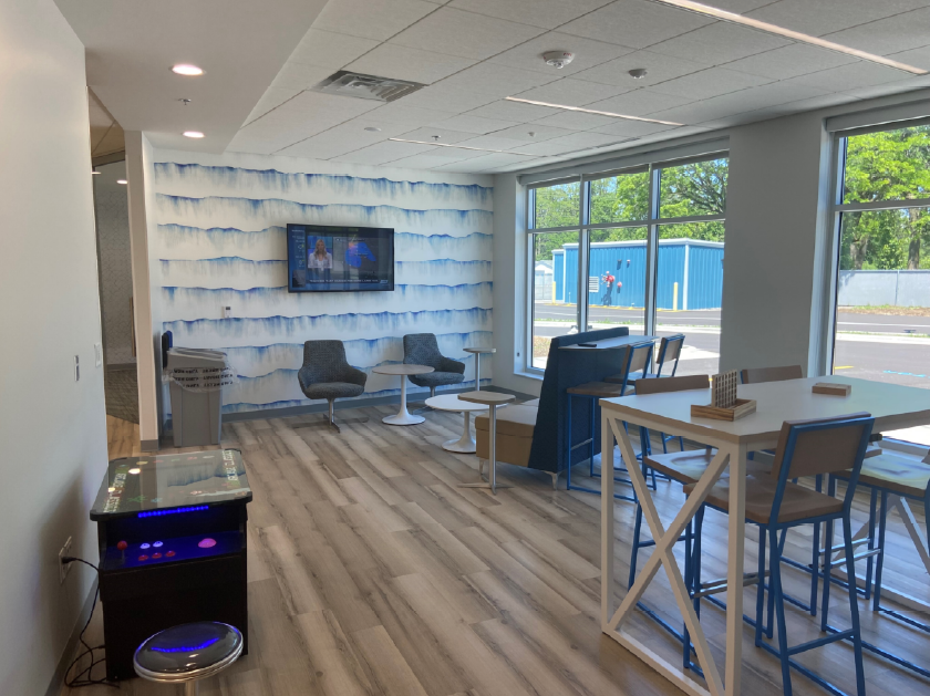 A view looking into another break room that creates a fun space for employees to connect and recharge.