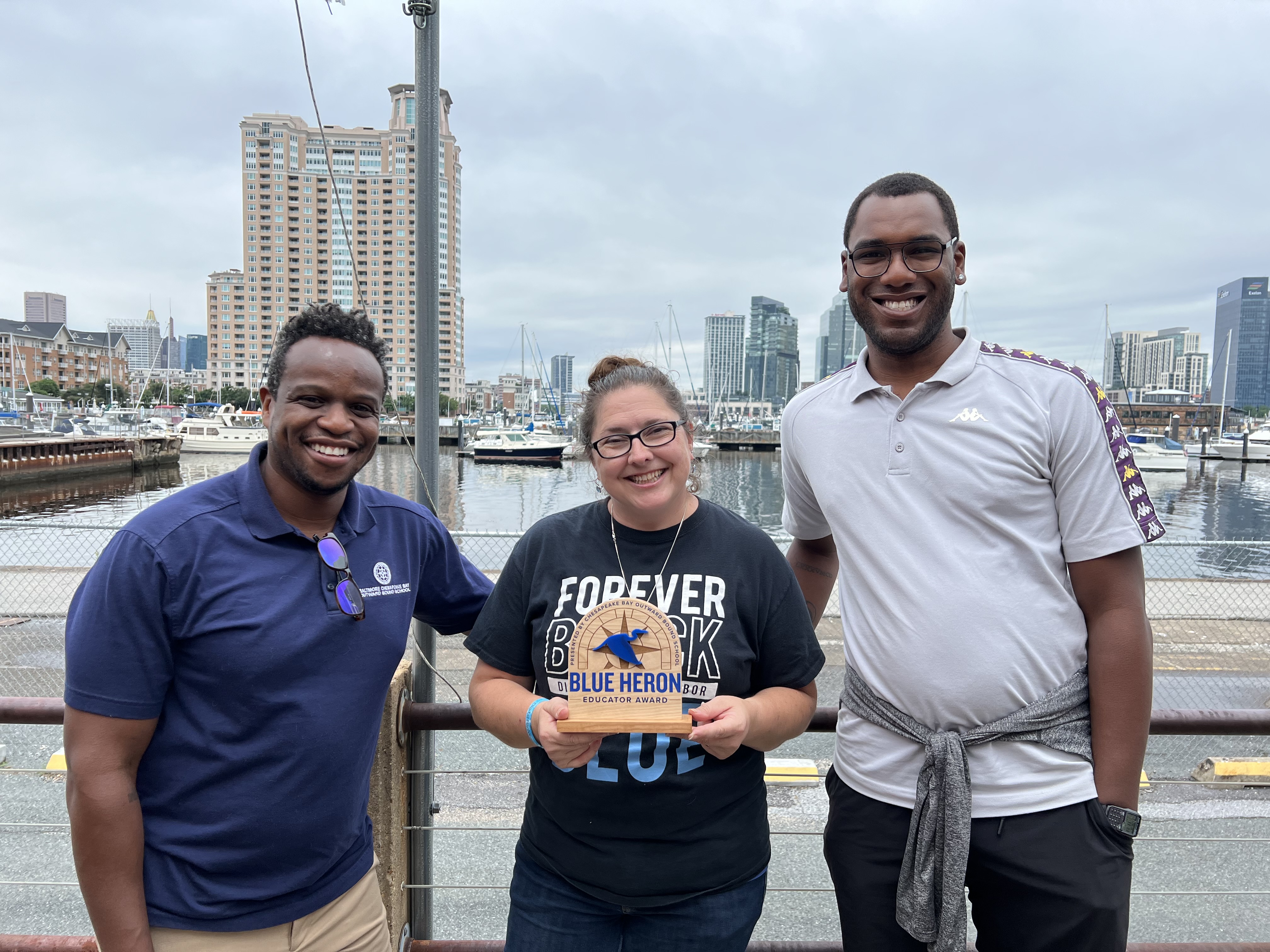 Nicole Veltre-Luton, Digital Harbor High School holding the 2022 Blue Heron Educator Award (pictured with Hanibal Gnahoui, Khai Overton of Outward Bound) (Photo: Jen Cusick)