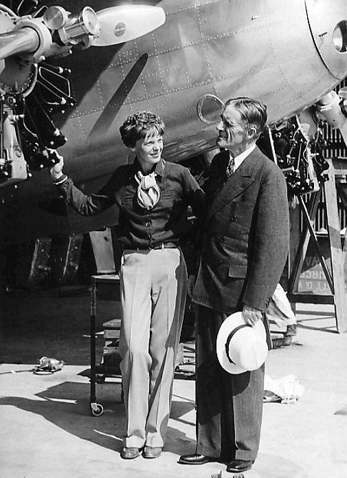 Amelia Earhart wearing her iconic trousers in front of Lockheed Electra in 1936 with Purdue University President Dr. Edward C. Elliott; courtesy Purdue University