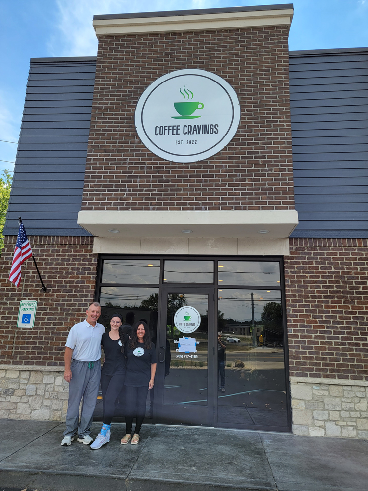 Stevenson family members stand in front of their new Coffee Cravings coffee shop in Yorktown, Indiana