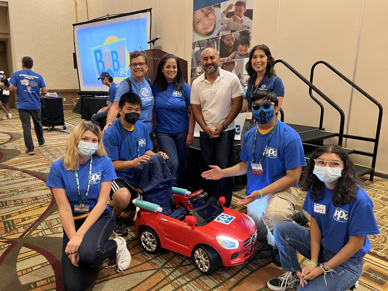 BGCA Senior Executive with BGCA teen leaders who completed the reconfiguration of an electric car pose with X-Bots Robotics Executive Director and BGC of Whittier staff.