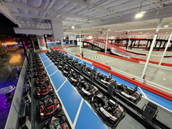 The interior of K1 Speed Fairfield showcasing go karts and indoor elevated kart track