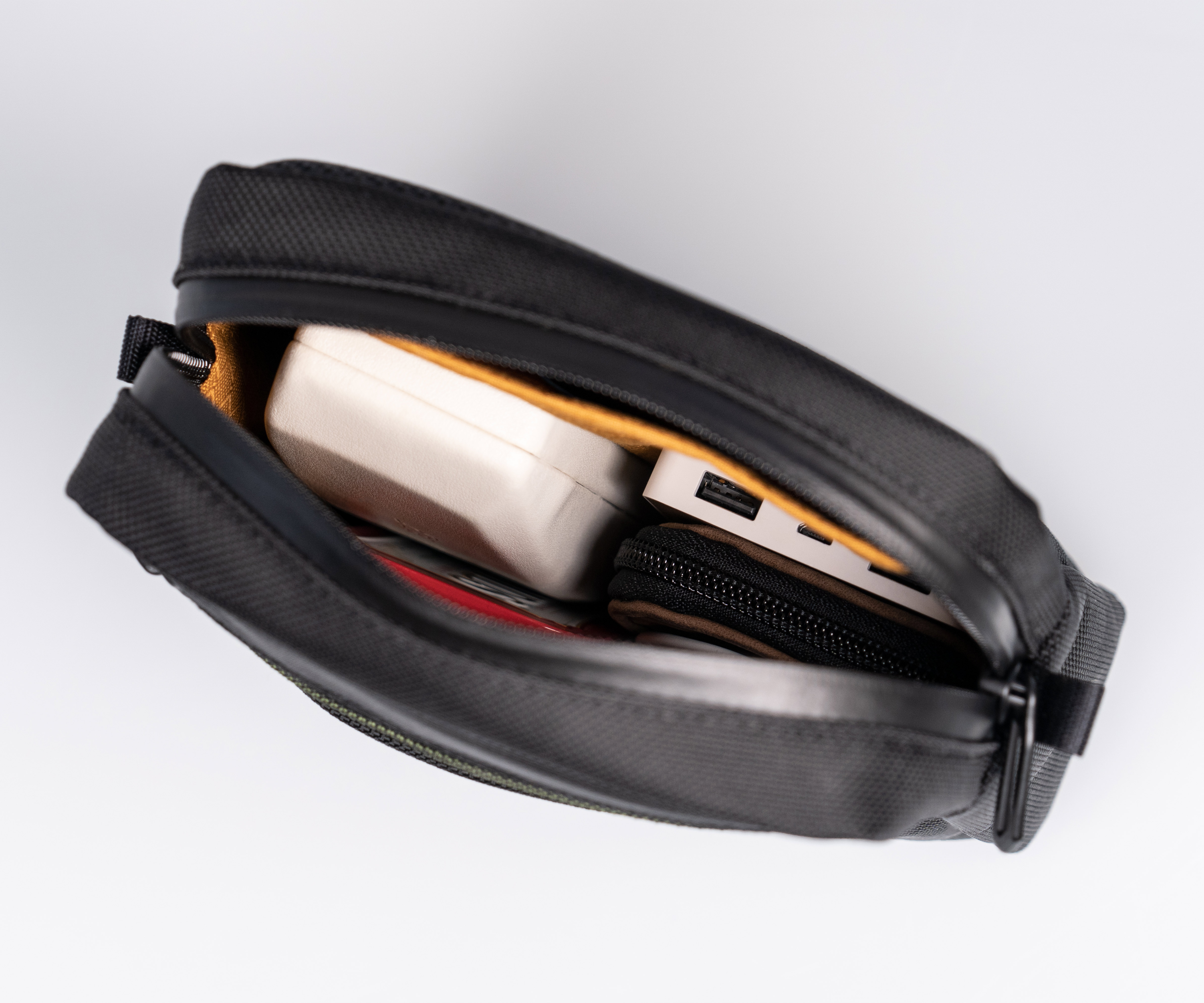 Waterproof, zipper-secured main compartment holds bulkier items & iPad mini