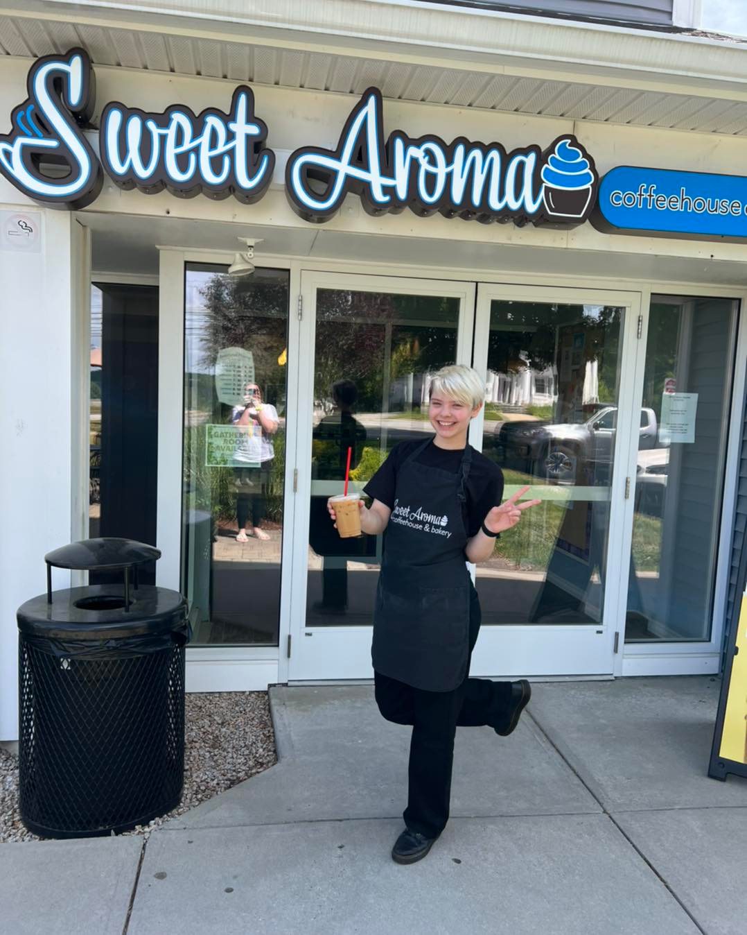 Barista outside Sweet Aroma Coffeehouse & Bakery open in Colchester, Connecticut