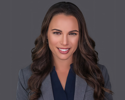 Headshot of attorney Nicole Martell on a grey background