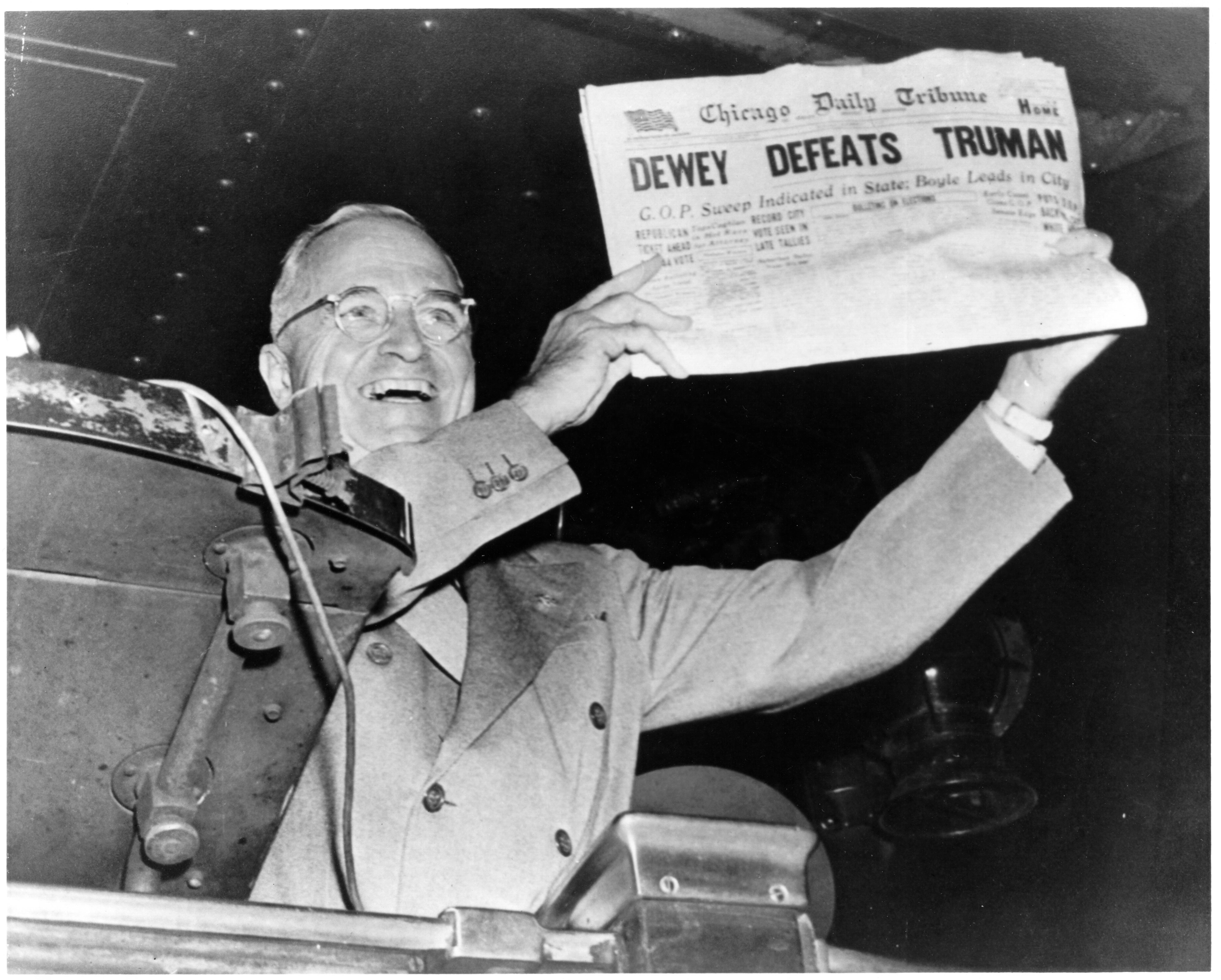 President Truman holds up Chicago Tribune with headline "Dewey Defeats Truman" at train station in St. Louis, Mo, Nov. 4, 1948.