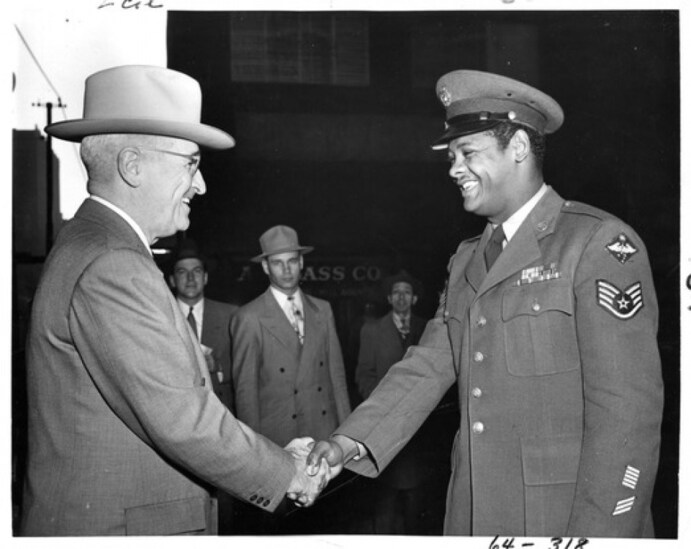 President Harry S. Truman exchanges a handshake with U.S. Air Force Staff Sergeant Edward Williams of St. Louis, Mo., Oct. 12, 1950; photo courtesy Harry S. Truman Presidential Library