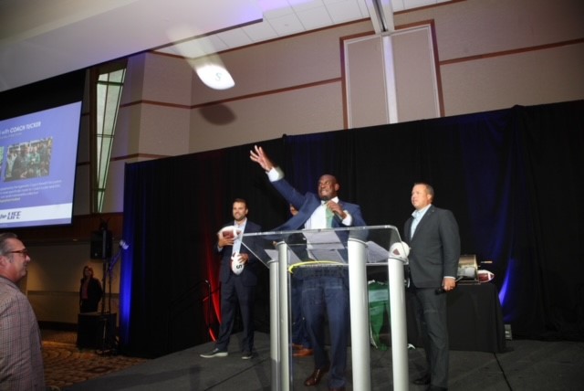 Coach Mel Tucker throwing autographed footballs out to the crowd who paid $1000 at the 40th Annual Drive for Life Foundation Gala.
