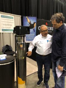 Julio Torres explains to a potential customer how water filtration works.