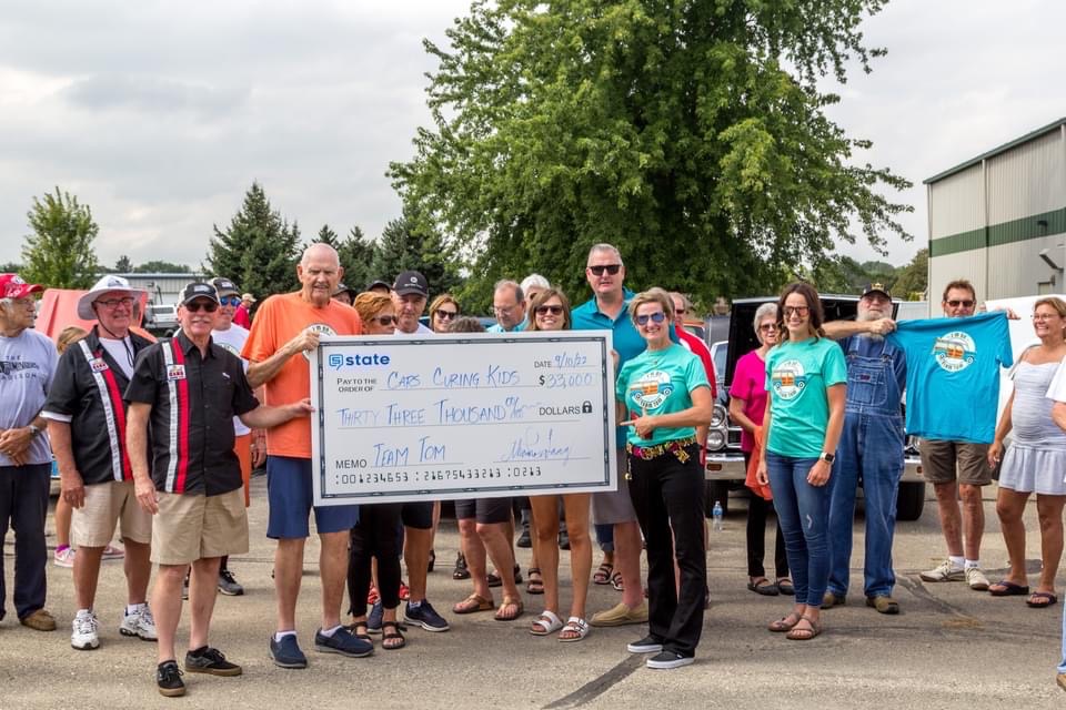"Team Tom" campaign check presentation. An additional $4,000 was raised at the event, a show featuring Tom Haag's extensive car collection.