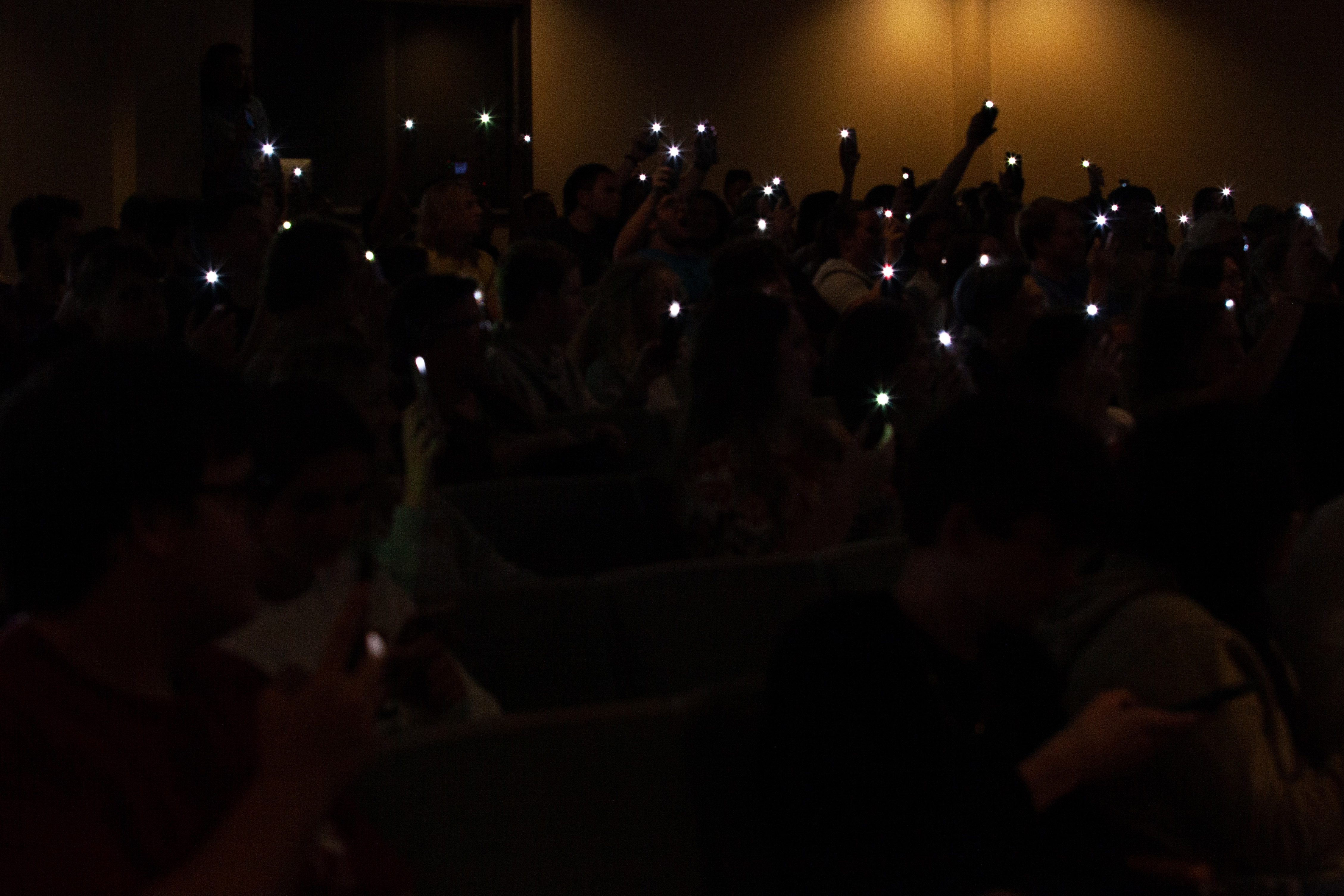 FHU students use their cellphone flashlights to resemble the light of fireflies, one of the animals that Aimee Nezhukumatathil celebrates in her poetry.