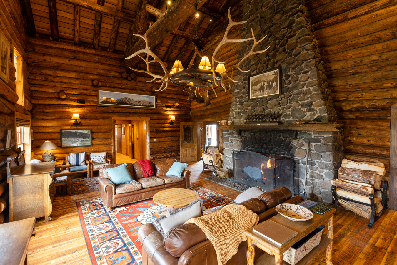 Gathering around crackling fires in the historic lodge’s giant stone fireplaces, guests enjoy cozy relaxation after a day’s snowy outdoor adventure in the Shoshone National Forest setting.