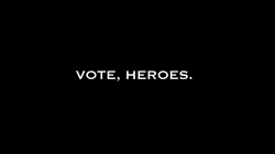The image is a black background with the words that read Vote, Heroes.