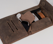 Time Travel Case interior — pleated pocket stows charger and watch face inside an Ultrasuede pouch, opposite side organizes and showcases up to three watch bands