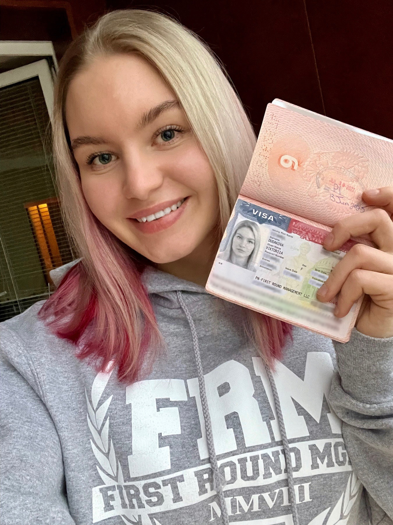 Dudakova holds her passport allowing her entry to the U.S