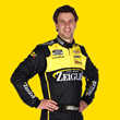 IMAGE: NASCAR driver Josh Bilicki in Zeigler Auto Group racing suit with Live Fast Motorsports badging on yellow background