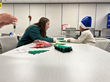 An AprilAire employee works one-on-one creating Christmas crafts.