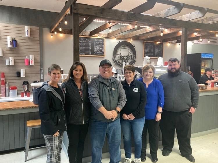 Owners John and Connie McGee (center) pose with their team inside Smoke-N-Beans Coffee Bar.