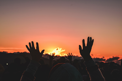 Photo by Carlos Surubi Ribera: https://www.pexels.com/photo/silhouette-of-people-raising-their-hands-during-sunset-4486901/