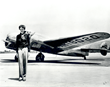 Amelia Earhart standing in front of the Lockheed Electra 10-E that she flew on her final flight in 1937.