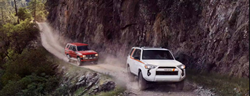 front view of two 2023 Toyota 4Runners driving in a lane