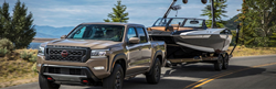2023 Nissan Frontier Gray towing a boat