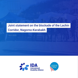 "Joint statement by the International Disability Alliance and European Disability Forum regarding the blockade of the Lachin Corridor, Nagorno-Karabakh" set against a blue background. In the background, you can barely make out a photo of the tents in the Lachin Corridor. Below the text, there are the logos of the IDA and EDF on a white background.