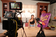 A dual VR and 2D setup captures "Making It VRy Big" host Twaydabae as she prepares to reveal the giant Takis she created.