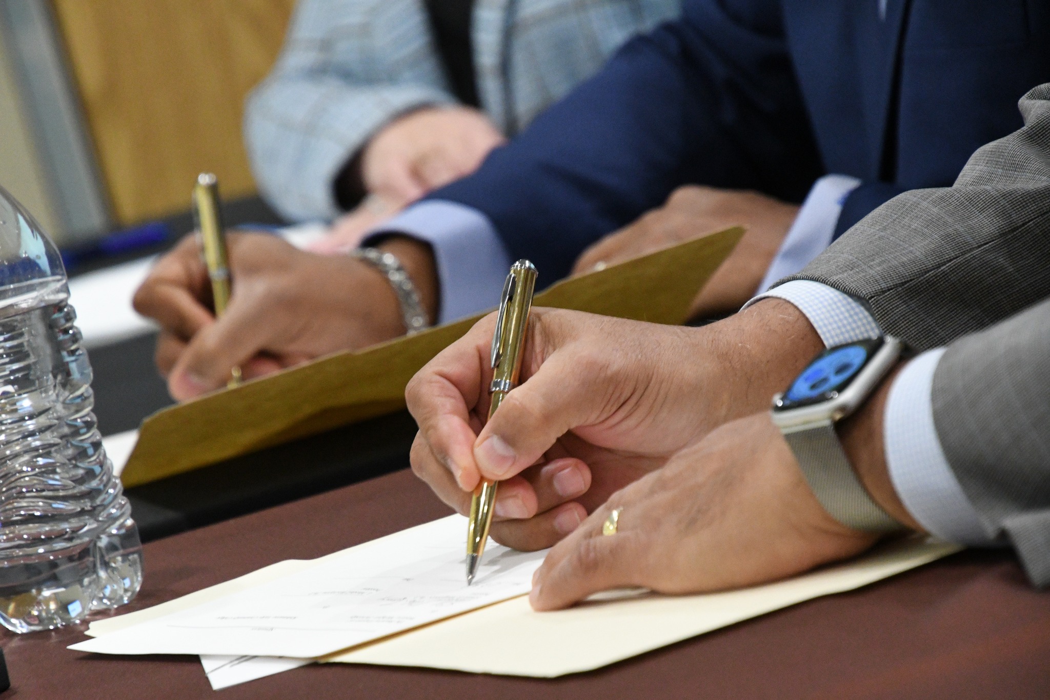 Signing the agreement: Pictured are the hands of, from left, L. Marshall Washington, Ph.D., president of Kalamazoo Valley, and Edward Montgomery, Ph.D., president of Western Michigan University