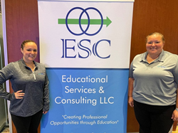 Educational Services & Consulting (ESC) staff standing next to ESC banner